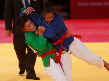 Uzbekistan's Gulnor Sulaymanova ,in green, competes against India's Pingky Balhara during their women's -52kg final kurash match at the 18th Asian Games in Jakarta. AP