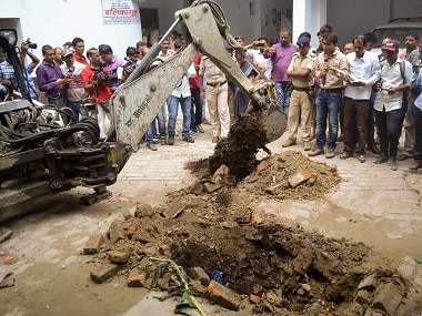 Police investigate the site where a rape victim was allegedly buried at a shelter home in Muzaffarpur. PTI