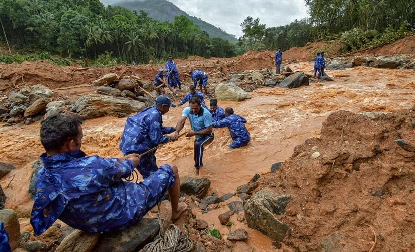 Rescue workers search for the bodies of missing persons after a landslide, triggered by heavy rains and floods, at Nenmara in Palakkad. PTI