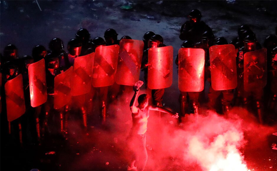 The expatriates said they were angry at how Romania is being governed. An estimated three million Romanians live abroad, and some say they left because of corruption, low wages and a lack of opportunities. A man throws a plastic bottle at riot police during protests. AP The expatriates said they were angry at how Romania is being governed. An estimated three million Romanians live abroad, and some say they left because of corruption, low wages and a lack of opportunities. A man throws a plastic bottle at riot police during protests. AP