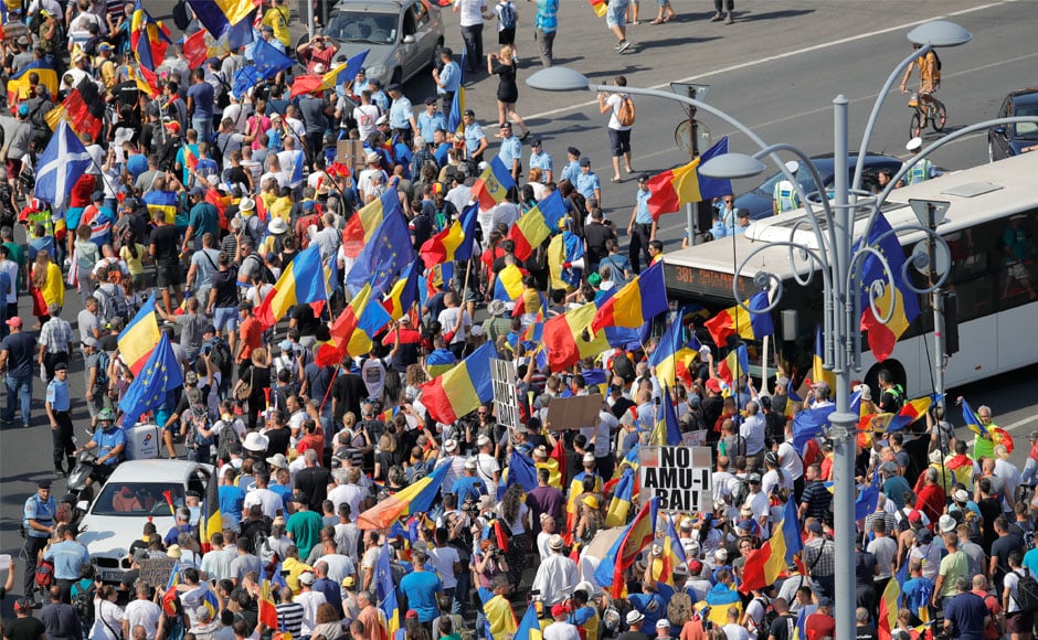 The protesters in the capital on Friday waved Romanian, European Union, Spanish, Italian and other national flags, and yelled The protesters in the capital on Friday waved Romanian, European Union, Spanish, Italian and other national flags, and yelled