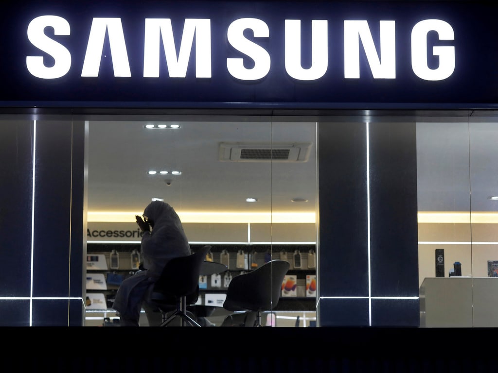 A customer prays inside a Samsung showroom in New Delhi, India. Image: Reuters