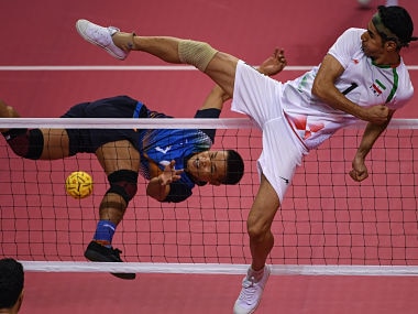 India's Thokchom Seitaram Singh jumps for the ball against Iran's Jafari Mehrdad during the sepak takraw men's team regu match during the 2018 Asian Games. AFP