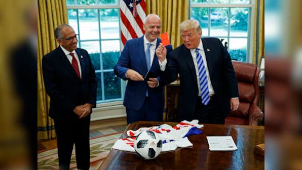US President Donald Trump shows press red card after welcoming FIFA boss Gianni Infantino to the White House