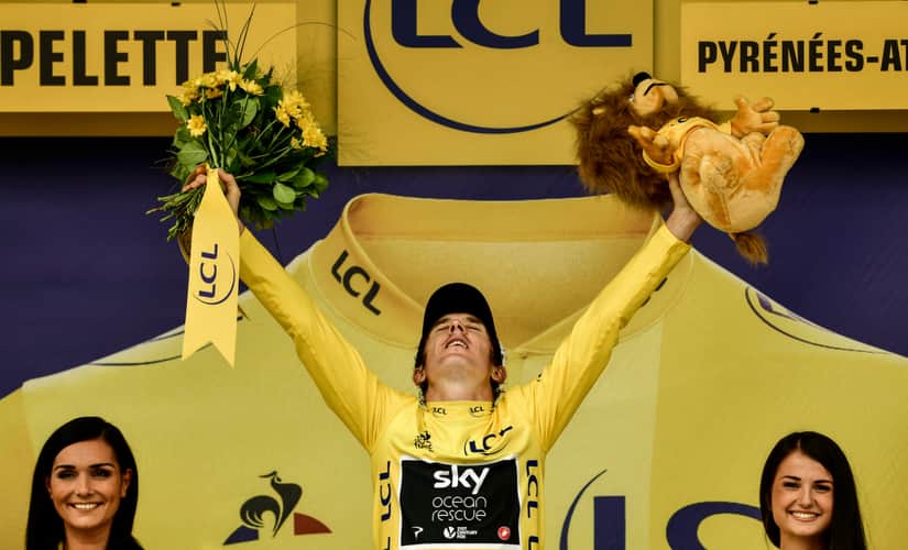 Geraint Thomas, wearing the overall leader’s yellow jersey, celebrates on the podium after the 20th stage of the 105th edition of the Tour de France cycling race. AFP