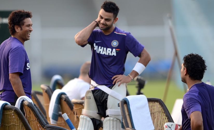 Learning from the master: Virat's rapport with his seniors is one of mutual respect and admiration. AFP