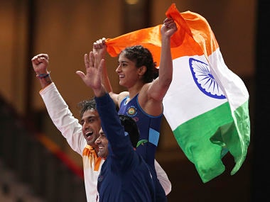 Vines Vinesh of India, top, reacts after beating Yuki Irie of Japan, during woman's freestyle 50 kg wrestling competition at the 18th Asian Games in Jakarta, Indonesia, Monday, Aug. 20, 2018. (AP Photo/Firdia Lisnawati)