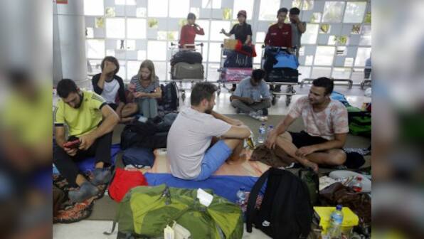 Tourists rush to escape Indonesia's Lombok as earthquake toll reaches 98; more than 20,000 left homeless