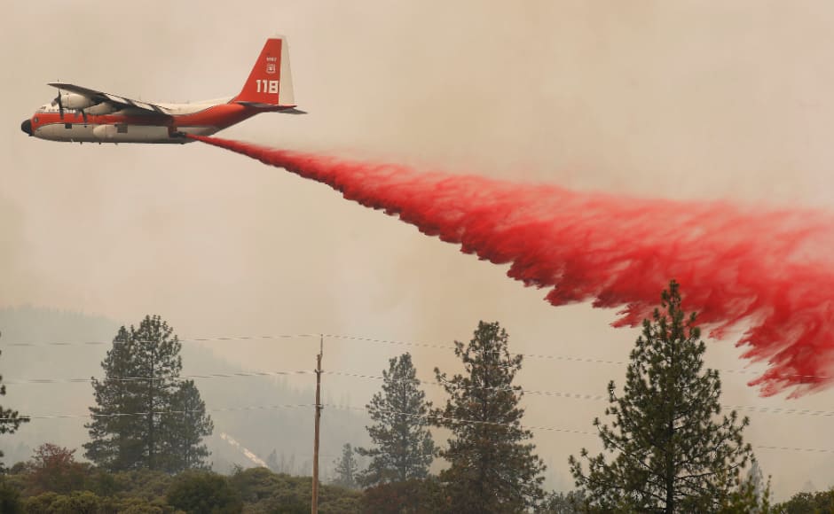 Fire retardant was also thrown by planes to slow the spread of the Carr Fire in California which engulfed the Redding city on 27 July. Reuters