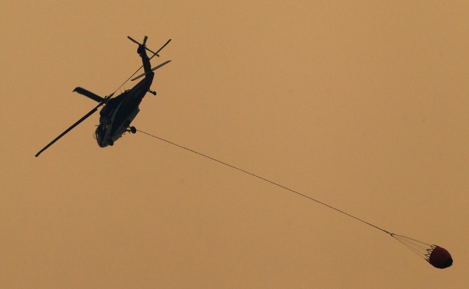 Water bombs were dropped by planes to control the Carr Fire in California’s Redding city. Reuters