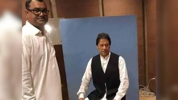 Pakistan's Prime Minister-in-waiting Imran Khan borrows waistcoat for official photo in Parliament