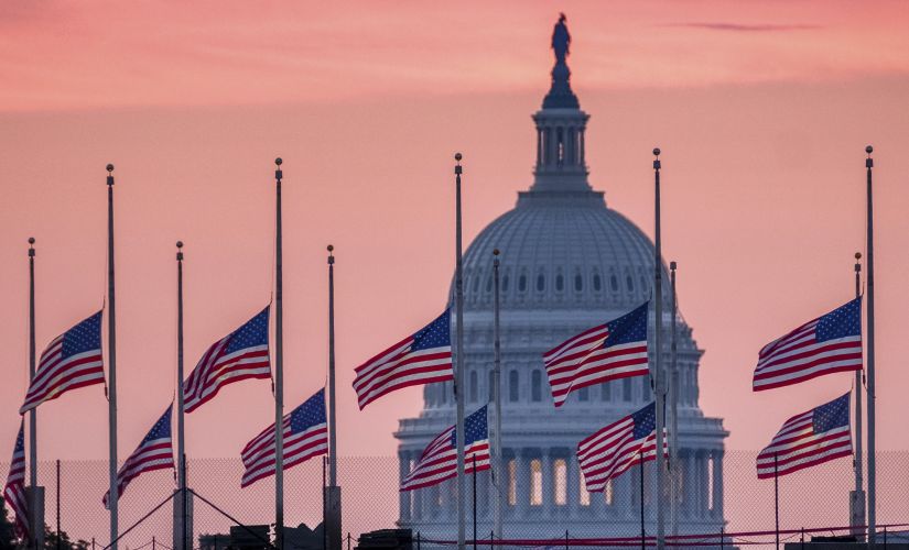 Flags flying a half-staff in honor of Senator John McCain at daybreak in Washington on Sunday. AP