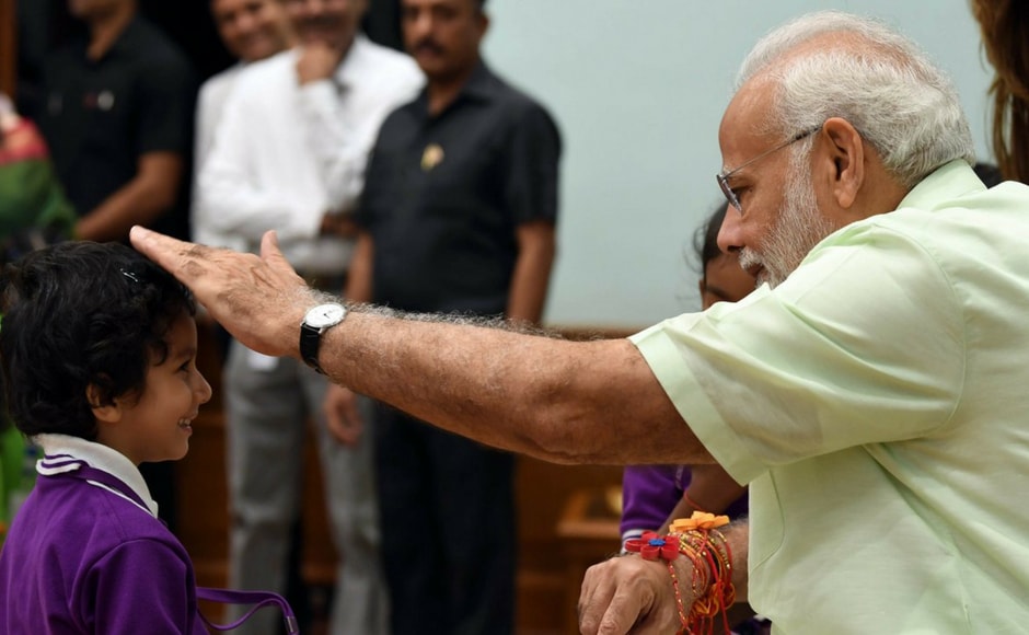 The prime minister blessed the girls who tied him a rakhi and wished the nation on social media. Twitter @BJP4India The prime minister blessed the girls who tied him a rakhi and wished the nation on social media. Twitter @BJP4India