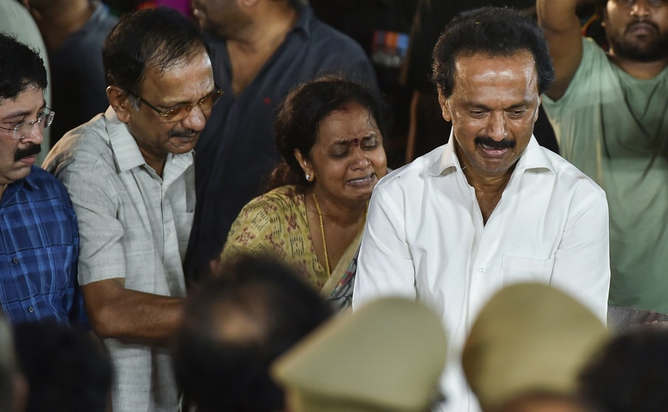 In poignant scenes, Stalin was seen crying inconsolably after touching his father's feet before the casket containing Karunanidhi's body was lowered into the grave at Marina Beach. The leader's youngest daughter Kanimozhi was also seen fondly caressing his head and cheek one last time. PTI In poignant scenes, Stalin was seen crying inconsolably after touching his father's feet before the casket containing Karunanidhi's body was lowered into the grave at Marina Beach. The leader's youngest daughter Kanimozhi was also seen fondly caressing his head and cheek one last time. PTI