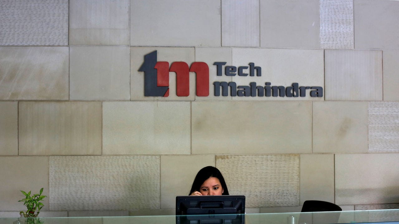 An employee sits at the front desk inside Tech Mahindra office building in Noida on the outskirts of New Delhi March 18, 2013. India's IT outsourcers are promoting
