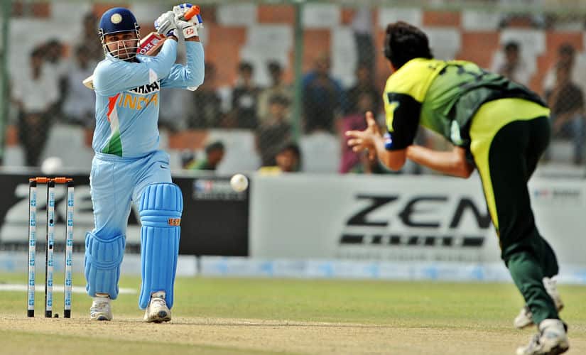Indian cricketer Virender Sehwag (L) plays a stroke during the Super League Asia Cup match between Pakistan and India at the National Stadium in Karachi on July 2, 2008. Pakistan suffered a major blow as their captain Shoaib Malik was ruled unfit in their crucial Asia Cup Super League match against India, who won the toss and opted to bat. AFP PHOTO/Aamir QURESHI / AFP PHOTO / AAMIR QURESHI