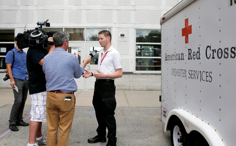 Investigators were working on Friday to pinpoint the cause of fire while a Red Cross employee briefed the media outside the Parthum School in Lawrence, Massachusetts. AP Investigators were working on Friday to pinpoint the cause of fire while a Red Cross employee briefed the media outside the Parthum School in Lawrence, Massachusetts. AP