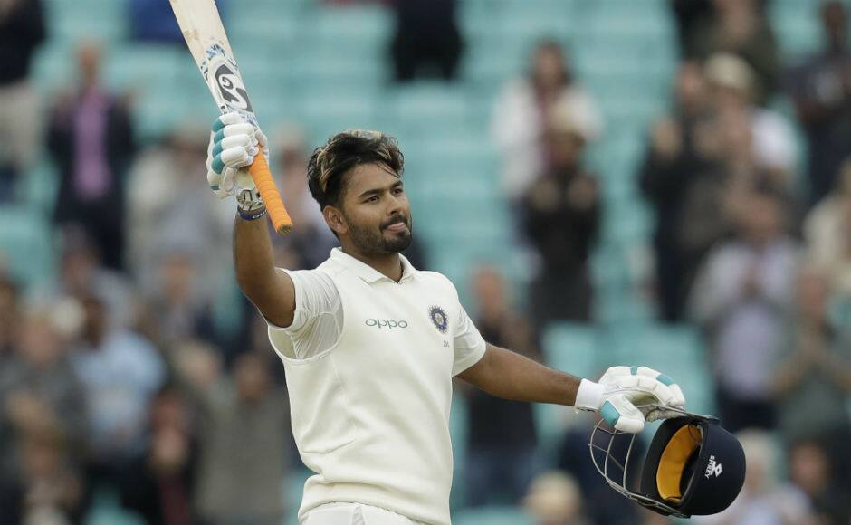 Rishabh Pant takes off his helmet and raises his bat after bringing up his maiden Test century. AP
