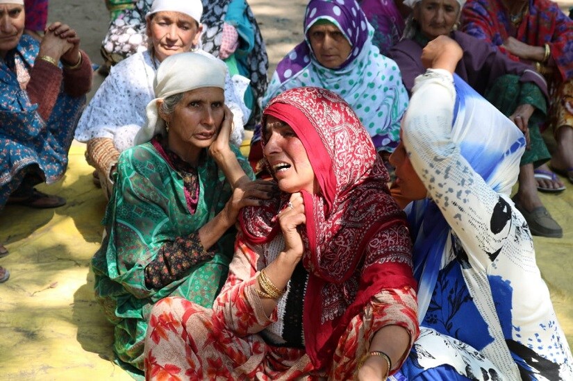 Murdered labourer Mushtaq Ahmed Mir's sister weeps at his funeral in Sopore's Harwan village. Image courtesy Sameer Yasir