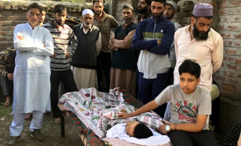 Yudvir Singh sits besides his father Kulwant Singh's body. Sameer Yasir