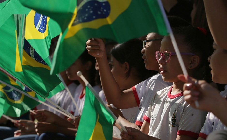 Brazilian children sang the national anthem and waved their country's flag at the parade. AP Brazilian children sang the national anthem and waved their country's flag at the parade. AP