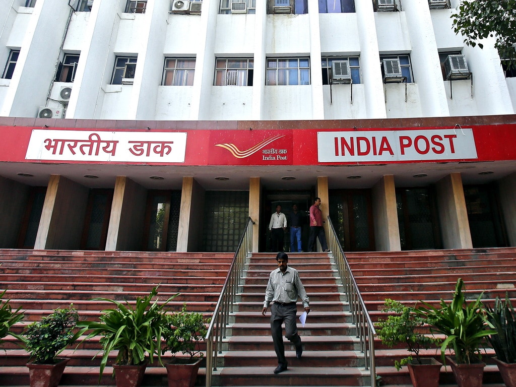 A man walks down the staircase of an Indian post office. Image: Reuters