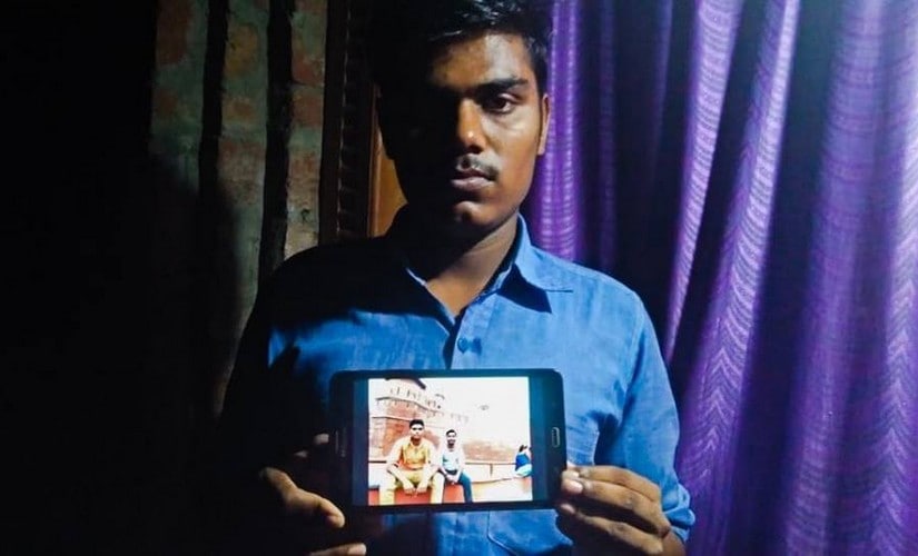 Krishan Yadav holds a picture of his cousin Pankaj who died while trying to clean a septic tank at DLF Capital Greens' residential complex in Moti Nagar. Pallavi Rebbapragada