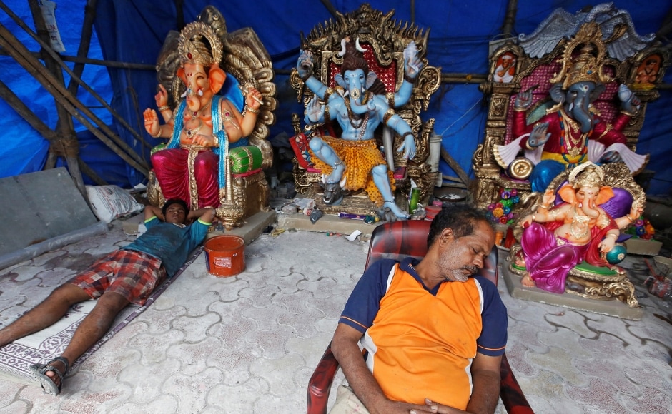 Workers fall asleep near idols on the first day of the ten-day-long Ganesh Chaturthi festival, inside a workshop in Mumbai. Reuters/ Francis Mascarenhas Workers fall asleep near idols on the first day of the ten-day-long Ganesh Chaturthi festival, inside a workshop in Mumbai. Reuters/ Francis Mascarenhas