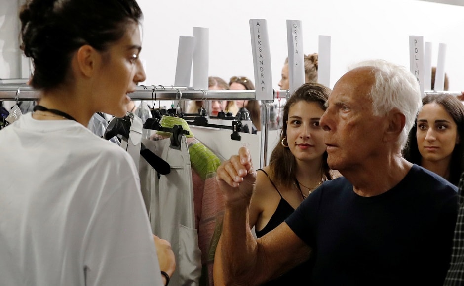 Italian designer Giorgio Armani talks with a model at the backstage before the Emporio Armani show at the Linate Airport during Milan Fashion Week Spring 2019 on 20 September. Reuters/Stefano Rellandini Italian designer Giorgio Armani talks with a model at the backstage before the Emporio Armani show at the Linate Airport during Milan Fashion Week Spring 2019 on 20 September. Reuters/Stefano Rellandini
