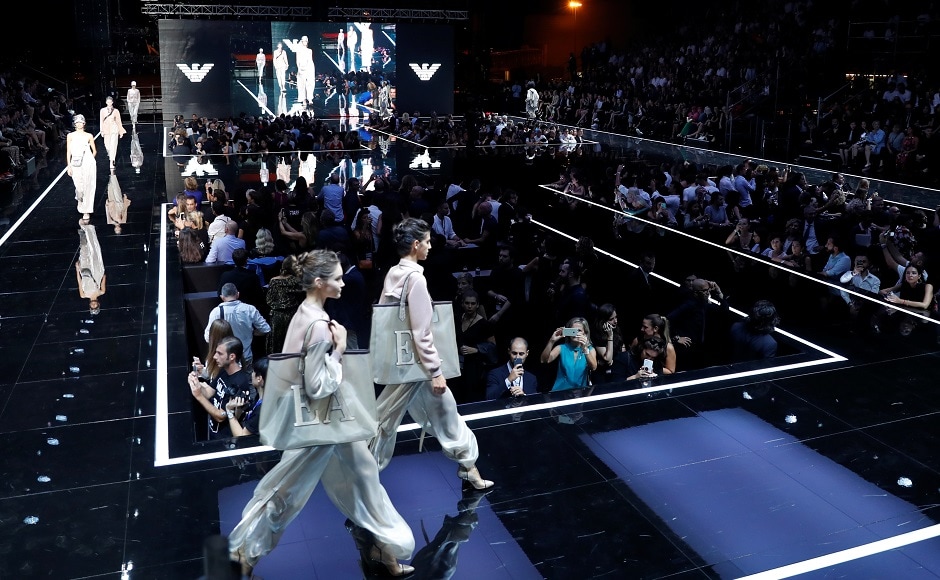 Sports-inspired layered looks, with lightweight windbreakers and anoraks were alternated with casual looks with ankle-high trousers worn under comfortable cotton jumpers. Models carried light backpacks and wore glasses and hats with flat shoes or sneakers on their feet. Reuters/Stefano Rellandini Sports-inspired layered looks, with lightweight windbreakers and anoraks were alternated with casual looks with ankle-high trousers worn under comfortable cotton jumpers. Models carried light backpacks and wore glasses and hats with flat shoes or sneakers on their feet. Reuters/Stefano Rellandini