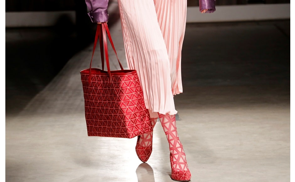 Nakashima's designs included many prints as well as wide trousers, flares and head foulards. Looks for men ranged from acetate sports ensembles to smarter suits, some with trousers and others with shorts. The 1960s were in full swing with high-waist and ankle-high dark blue trousers, worn by male models with cropped jackets. Women also wore dresses in broderie anglaise in yellow and white. Reuters/Stefano Rellandini Nakashima's designs included many prints as well as wide trousers, flares and head foulards. Looks for men ranged from acetate sports ensembles to smarter suits, some with trousers and others with shorts. The 1960s were in full swing with high-waist and ankle-high dark blue trousers, worn by male models with cropped jackets. Women also wore dresses in broderie anglaise in yellow and white. Reuters/Stefano Rellandini