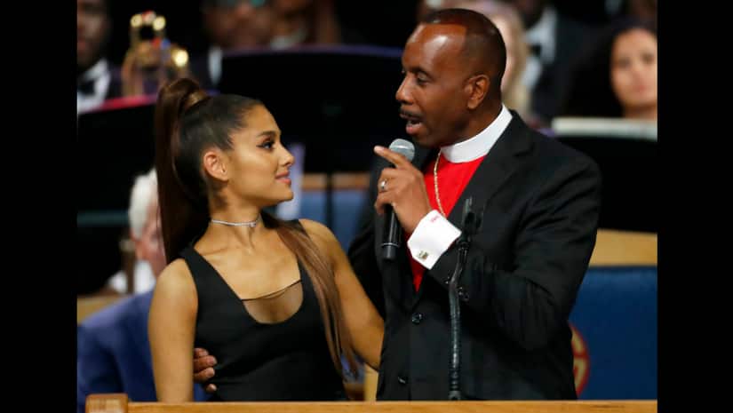 Bishop Charles H. Ellis, III, right, speaks with Ariana Grande after she performed during the funeral service for Aretha Franklin at Greater Grace Temple, Friday, Aug. 31, 2018. The Associated Press/ Paul Sancya