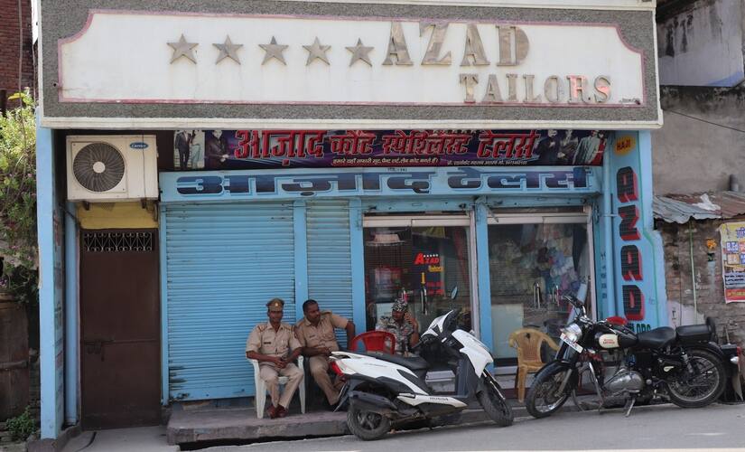 Policemen sationed outside Azad Tailors. Mirah Zamin
