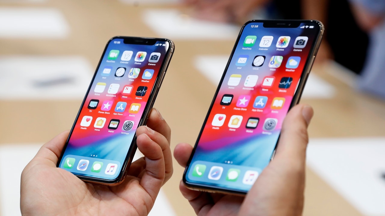 A man holds the newly released Apple iPhone XS and XS Max during a product demonstration. Image: Reuters
