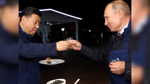 Vladimir Putin and Xi Jinping take break from economic forum, flip pancakes in Vladivostok city