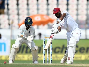 Indian wicketkeeper Rishab Pant (L) looks on as West Indies cricketer Roston Chase plays a shot during the first day’s play of the second Test cricket match between India and West Indies at the Rajiv Gandhi International Cricket Stadium in Hyderabad on October 12, 2018. (Photo by NOAH SEELAM / AFP) / —-IMAGE RESTRICTED TO EDITORIAL USE - STRICTLY NO COMMERCIAL USE—– / GETTYOUT