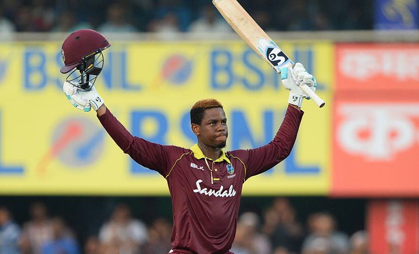 West Indies batsman Shimron Hetmyer raises his bat and helmet after he completed his century (100 runs) during the first one day international (ODI) cricket match between India and West Indies at Barsapara Cricket Stadium in Guwahati on October 21, 2018. (Photo by SAJJAD HUSSAIN / AFP) / —-IMAGE RESTRICTED TO EDITORIAL USE - STRICTLY NO COMMERCIAL USE—– / GETTYOUT