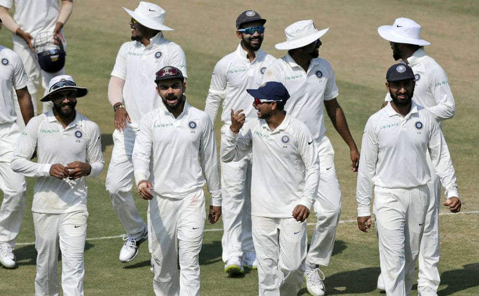 The victorious Indian team leave the field after going 1-0 up in the series with an innings win at Rajkot. AP