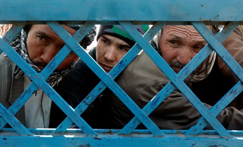 Afghani men stand in line to cast their vote. Reuters