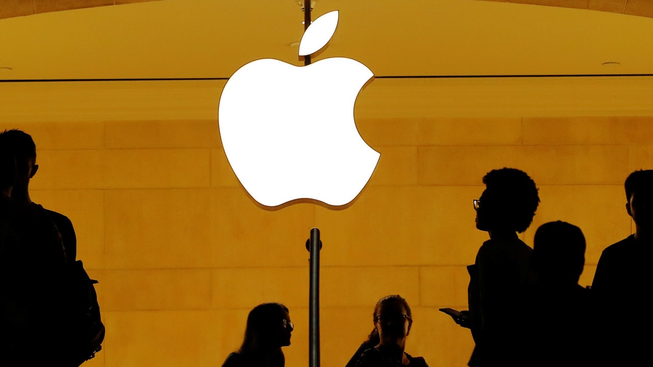 Customers walk past an Apple logo inside of an Apple store at Grand Central Station in New York, US. Image: Reuters