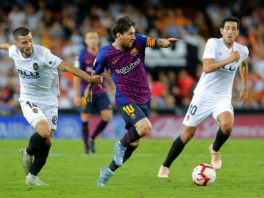 Barcelona's Lionel Messi in action with Valencia's Jose Gaya. Reuters