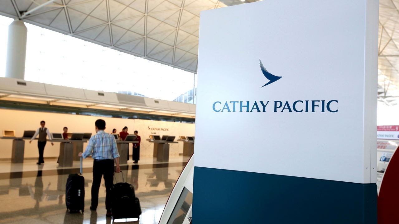 A passenger walks to the First Class counter of Cathay Pacific Airways at Hong Kong Airport in Hong Kong. Reuters.
