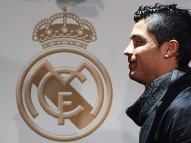 Real Madrid's Portuguese football player Cristiano Ronaldo poses at Santiago Bernabeu stadium in Madrid on December 16, 2009 with his biography "Suenos Cumplidos" (dreams accomplished) written by journalist Enrique Ortego. AFP PHOTO / PIERRE-PHILIPPE MARCOU (Photo by PIERRE-PHILIPPE MARCOU / AFP)