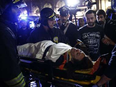 First responders evacuate a wounded person from Piazza della Repubblica in central Rome. AFP