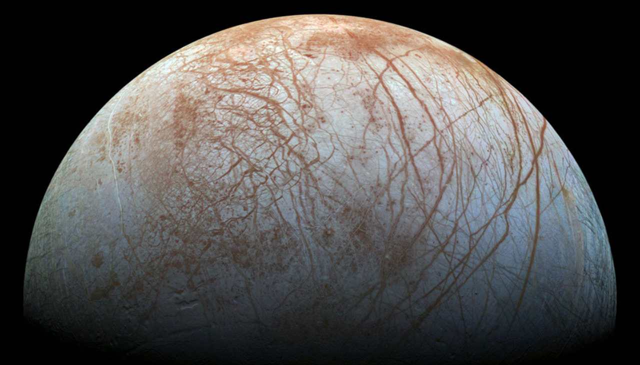 In this image captured during the Galileo mission in the 1990s, Europa's icy surface and the long fissures cutting through them are evident. Image courtesy: NASA