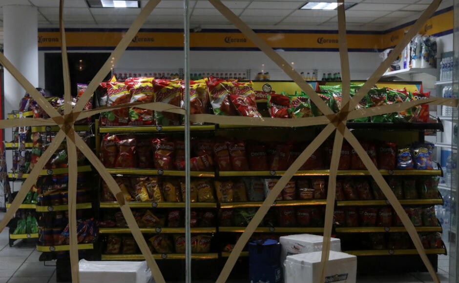 Glass panels at stores were taped-up to protect against the expected strong winds. Tour operators and fishermen also raced to tie down their boats ahead of the storm. Reuters Glass panels at stores were taped-up to protect against the expected strong winds. Tour operators and fishermen also raced to tie down their boats ahead of the storm. Reuters