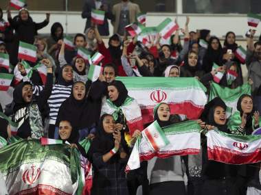 Iranian women cheer during the friendly football match between Iran and Bolivia at the Azadi Stadium in Tehran on October 16, 2018. (Photo by STR / AFP)