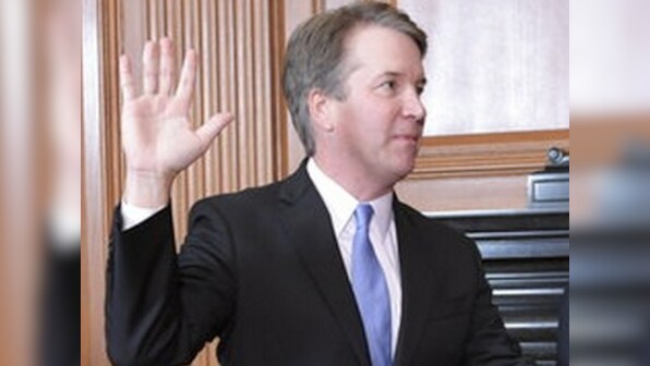 Brett Kavanaugh sworn to US Supreme Court after rancorous confirmation; Donald Trump flashes thumbs-up
