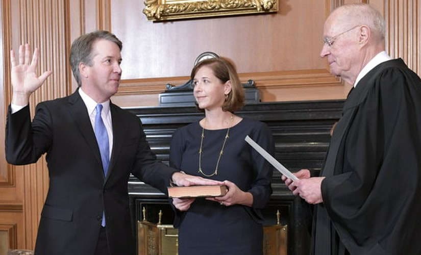 Brett Kavanaugh sworn to US Supreme Court after rancorous confirmation; Donald Trump flashes thumbs-up