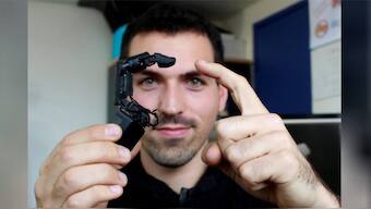 Robot finger that attaches to phones, wriggles across tables and stroke your hand